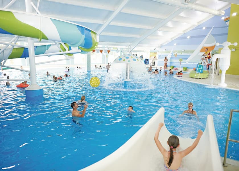 Indoor swimming pool and waterslide at accessible Somerset holiday park