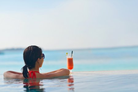 Woman relaxing in a pool in a luxury resort