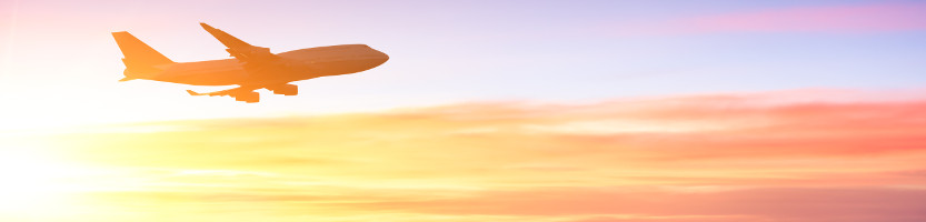 Aeroplane flying in the sunset