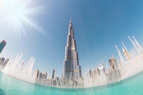 Burj Khalifa and fountains on a sunny day in Dubai, UAE